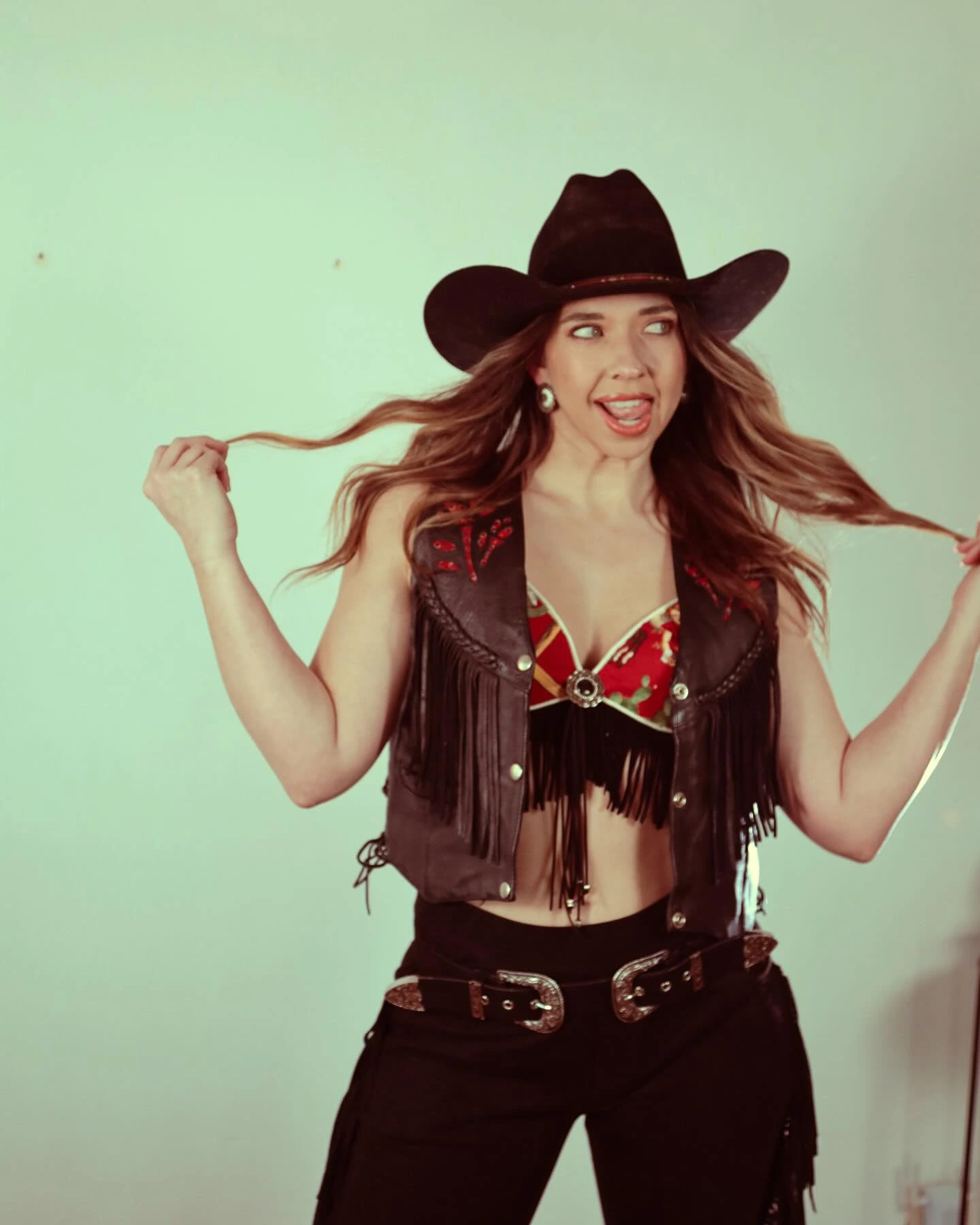Chelsey Webb portrait — black hat, fringe vest